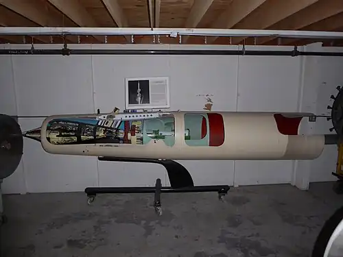Marquardt RJ43 supersonic ramjet. This cutaway museum exhibit shows the 3 components of a ramjet, diffuser, combustion chamber and nozzle. At supersonic airspeeds air compression starts at the tip of the diffuser cone and continues internally due to internal air passage contours between the black centerbody and duct inner wall as far as the red high-blockage grid[10] then combustion in the cylindrical section after the yellow fuel nozzles and as far as the nozzle entry, then expansion through the convergent/ divergent nozzle.[11]