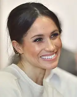 A close-up photograph of Meghan smiling