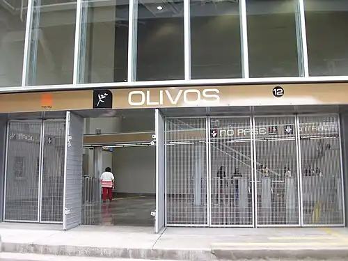 Picture of an entrance to the station, which is a metallic fence. The turnstiles can be seen in the background.