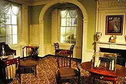 A room in the neoclassical style, displaying antique furniture and decor