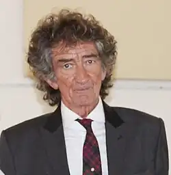 Kellie dressed in a suit, looking to the camera