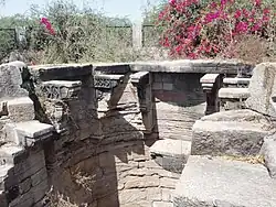 Well-shaft with three pairs of struts decorated with motifs of diamond (ratna) and kirtimukha