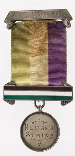 A medal, made of fabric and metal, suitable for pinning on one's chest, reading "For Valor; Hunger Strike"