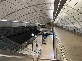 Picture of North Ryde station from the outside. It consists of a small entrance building, with most of the station below ground and not visible in the image.