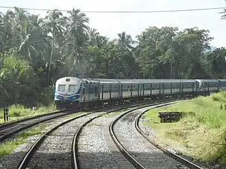 A passenger train rounds a curve