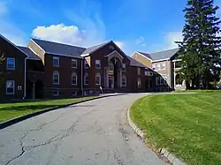 Picture of a building with a road leading up to it. The Oddfellows building houses the departments of English, Religious Studies, and Philosophy as well as the Meadville Community Theater and Child Care programs. Photo courtesy
