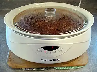 A slow cooker with button controls and a digital timer