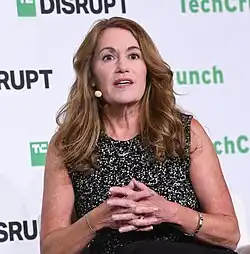 Johnson speaking toward audience during panel discussion