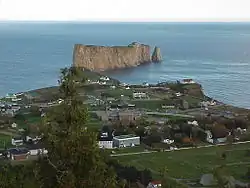 An aerial view of the village of Percé, Quebec, and its famous rock, taken from Mont-Sainte-Anne