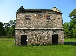 Doocot (English 'Dovecote') at Pinkie House with Seton's characteristic cipher of a crowned crescent and cinquefoil over door to right