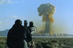 An airmen from the 1352d Photographic Squadron filming the blast