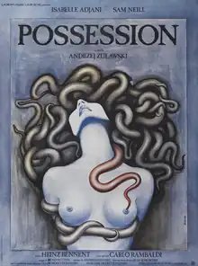 On a slate gray background, a naked woman is seen from the waist up. Tentacles replace her hair, tie her hands behind her back, and run under her breasts.