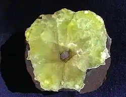 Sliced prehnite fragment with calcite core, 9.0&nbsp;cm diameter.