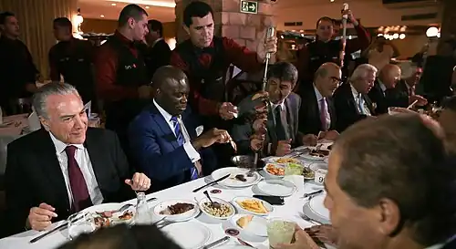 Brazilian politicians being served rodízio style
