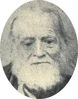 Slightly blurry photograph of an old man with a white beard