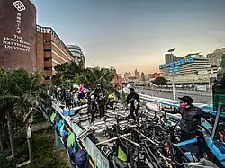 Protesters walking on the rooftop of the bridge connecting PolyU and nearby districts