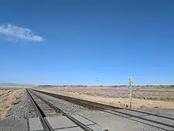 Railroad crossing in Black Rock with the namesake black rock formations in the background.