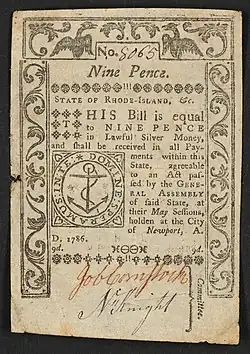 A nine-pence banknote issued by Rhode Island in 1786 with the inscription: ""STATE OF RHODE-ISLAND, &c. THIS Bill is equal to NINE PENCE in Lawful Silver Money, and shall be received in all Payments within this State, agreeable to an Act passed by the GENERAL ASSEMBLY of said State, at their May Sessions, holden at the City of Newport, A. D. 1786. 9d." ; "Committee" is written vertically, to the right of the signatures. ; Within seal: "DOMINE SPERAMUS IN TE".