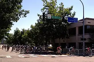 A large group of bicyclists turn onto NE 85th Street in Redmond, WA, during Redmond Derby Days