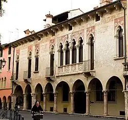 Façade of a late Gothic palace with distinctive windows.
