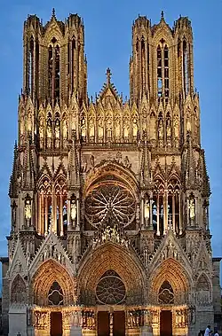 Notre-Dame de Reims façade, gothic stone cathedral against blue sky