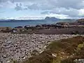 Rubh a Choin Rocky shoreline near the end of the peninsula between Garvie and Achnahaird bays. Suilven in the distance across Enard Bay.