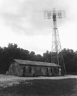 SCR-271 radar tower next to a small building.