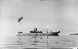 Antenna raising in 1915. The kite balloon ship HMS CANNING anchored off Salonika with kite balloon aloft, November 1915.