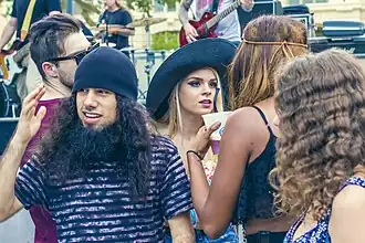 Young adults wearing festival styles at an outdoor event in Sacramento, 2015.