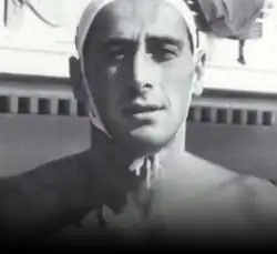 black & white portrait of a bare=chested Caucasian male wearing a swimming bonnet