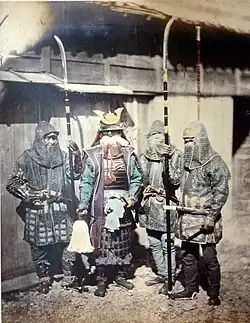 1870 photograph of samurai and retainers wearing mail armour and holding naginata
