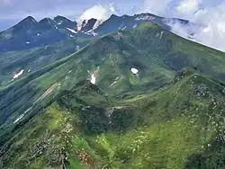 The mountains of the Shiretoko Peninsula from Mount Rausu (July 2007). In the foreground is Mitsumine, in the middle field is Mount Sashirui, and in the background is Mount Iō