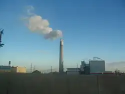 A smokestack releasing smoke (from Economics)