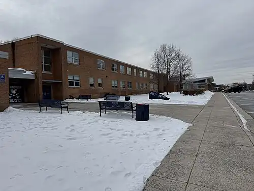 View of exterior of Woodson HS on a snowy afternoon