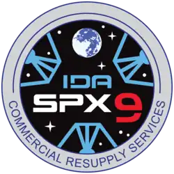 NASA's SpX-9 mission patch graphic simulates the view from inside IDA-2, displaying the three petals of the docking adapter.