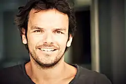 A German man with brown hair and eyes