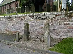 Parish stocks outside St Luke's parish church, Weston