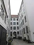 The first courtyard with the rear side of the building fronting the street