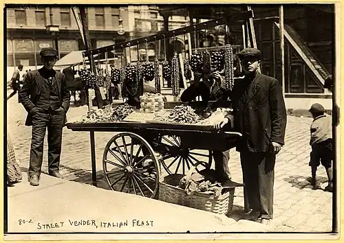 A street vender (costermonger) with food cart (1908)