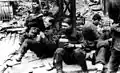 SS soldiers pause to eat during the suppression of the Warsaw ghetto uprising