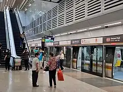 Platform E of Outram Park MRT station serving TEL services towards Bayshore MRT station. There is a train at the platform, and the platform doors are open.