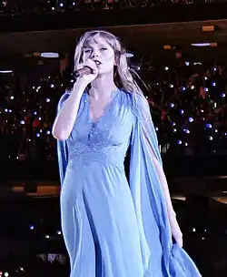 Photo of Taylor Swift singing into a microphone