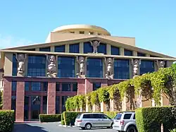 building with part of the columns being held up by statues of the seven dwarfs from Snow White