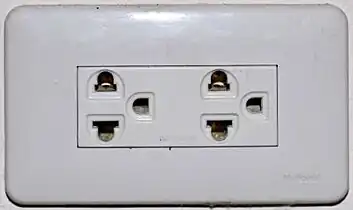 An earthed Thai socket that complies with figure&nbsp;4 of TIS&nbsp;166-2549. Although it accepts NEMA plugs, the Thai voltage is 220&nbsp;V and thus is electrically incompatible with devices designed only for 120&nbsp;V.