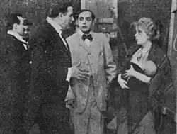 Black and white film still showing actors in period costume