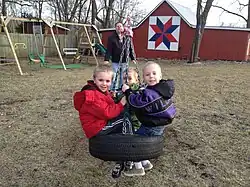 Children on a tire swing