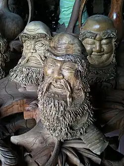 Three carved wooden heads
