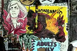 Close up photo of street art of a woman, overlapping multiple posters