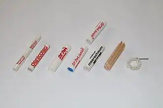 Smoking pipe filters. Left to right: 6&nbsp;mm paper. 6&nbsp;mm charcoal. 9&nbsp;mm paper. 9&nbsp;mm charcoal one-sided. 9&nbsp;mm meerschaum. 9&nbsp;mm balsa wood. Falcon dry ring.