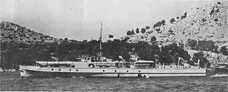 a black and white photograph of a ship underway